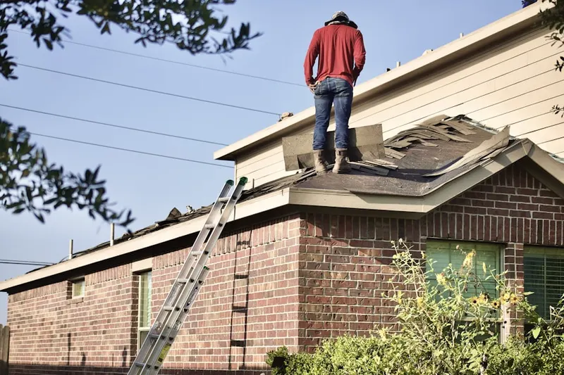 Professional roofer working on a residential roof in Delmar